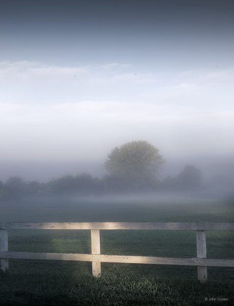 fence-in-rising-fog
